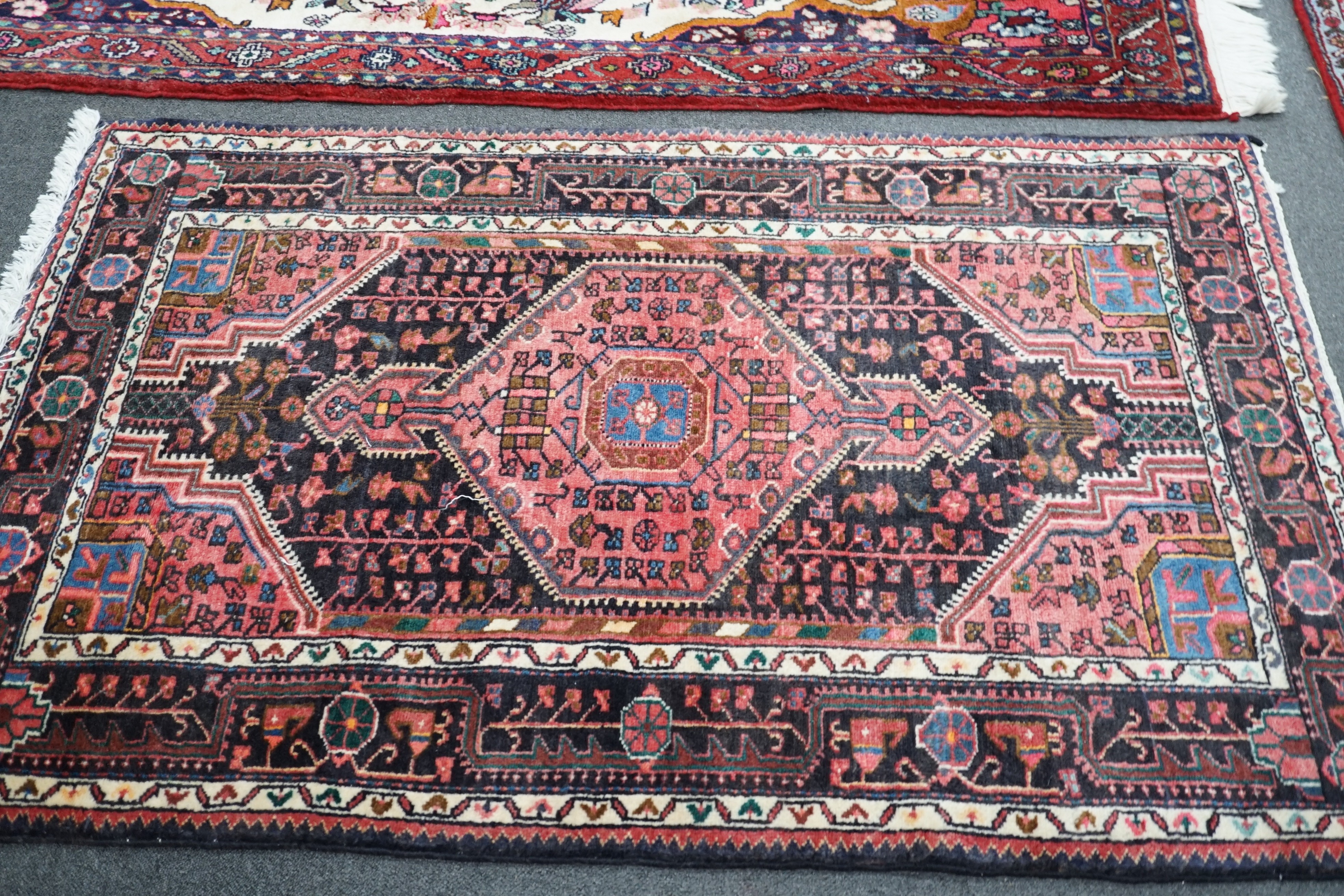 A North West Persian ivory ground rug, 220 x 140cm, and a smaller blue ground rug